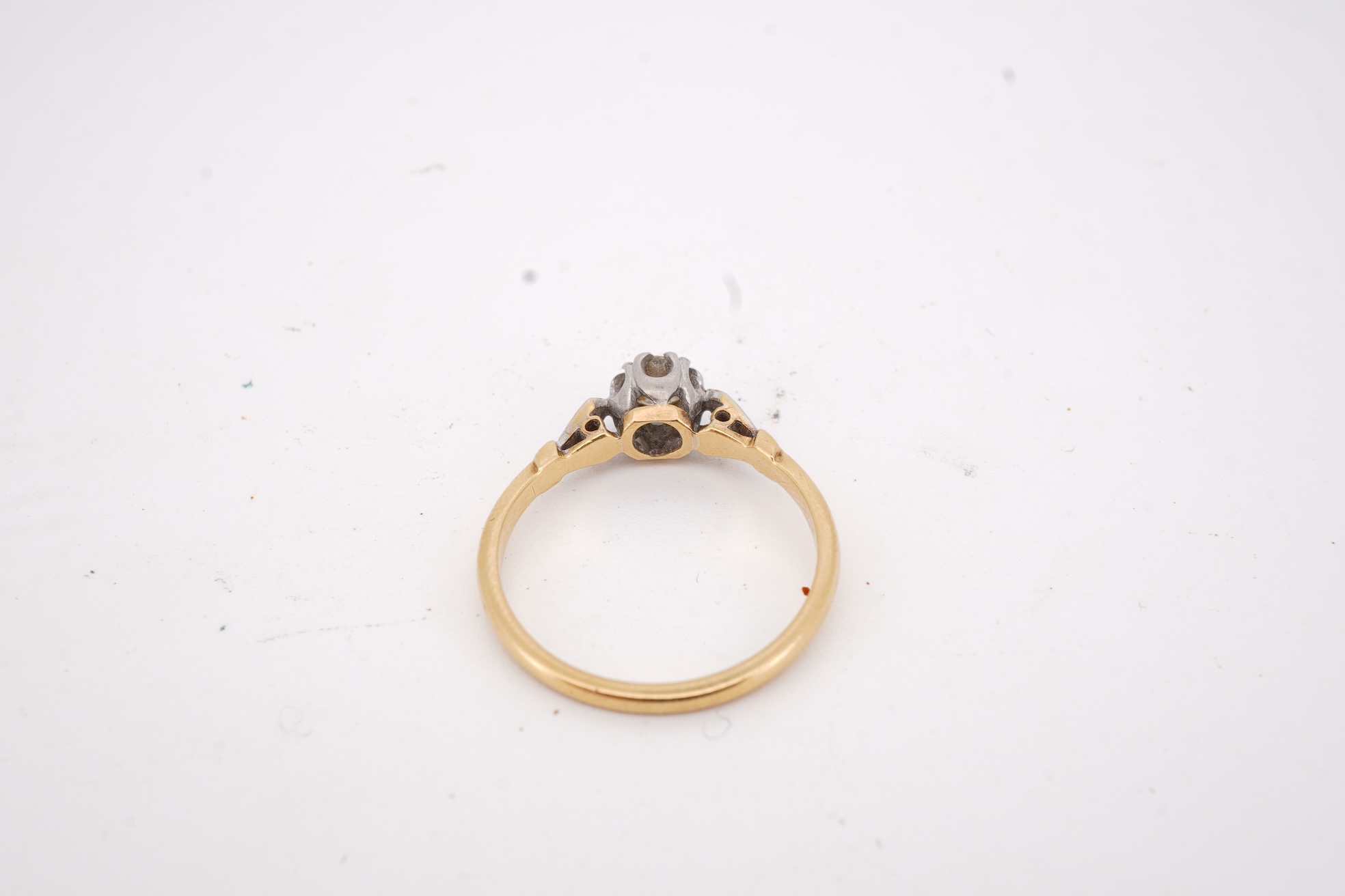 A diamond ring, set with a brilliant-cut diamond weighing approximately 0.20 carats, mounted in gold and platinum, size O1/2, stamped 18CT PLAT, gross weight approximately 2 grams, Condition: good, minor wear, diamond es